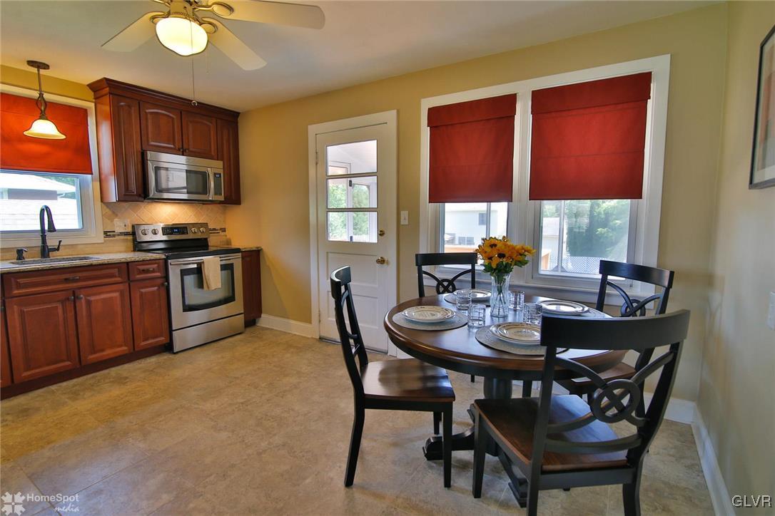 538 School Road Nazareth, PA 18064 - Photo 8 of 29 a kitchen with a stove a sink dining table and chairs