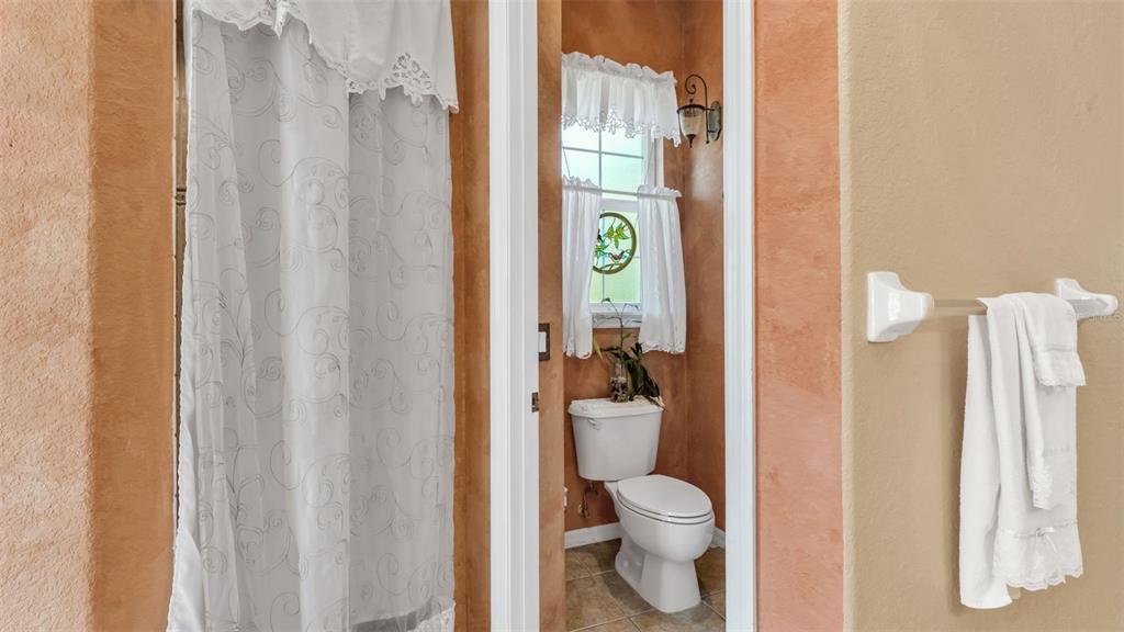 237 McLean Point Winter Haven, FL 33884 - Photo 18 of 85 a white toilet sitting next to a bathroom sink