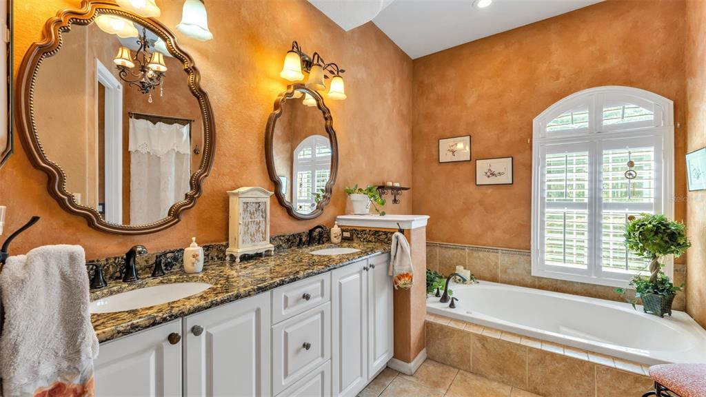 237 McLean Point Winter Haven, FL 33884 - Photo 21 of 85 a bathroom with a double vanity sink and a mirror