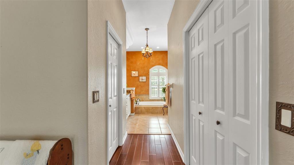 237 McLean Point Winter Haven, FL 33884 - Photo 22 of 85 a view of a hallway with wooden floor and staircase
