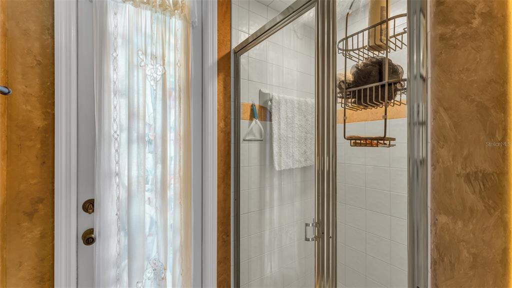 237 McLean Point Winter Haven, FL 33884 - Photo 28 of 85 a bathroom with a glass door and shower