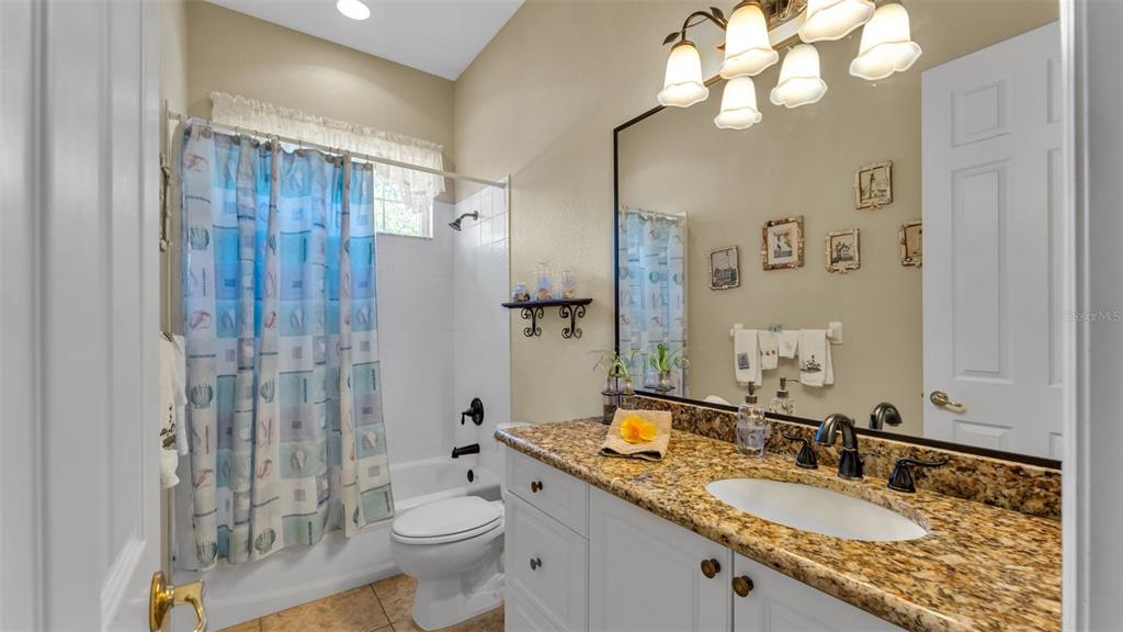 237 McLean Point Winter Haven, FL 33884 - Photo 31 of 85 a bathroom with a granite countertop sink toilet and shower