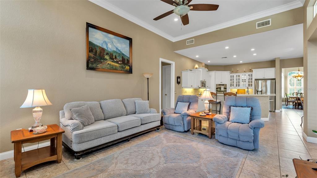 237 McLean Point Winter Haven, FL 33884 - Photo 34 of 85 a living room with furniture and a chandelier