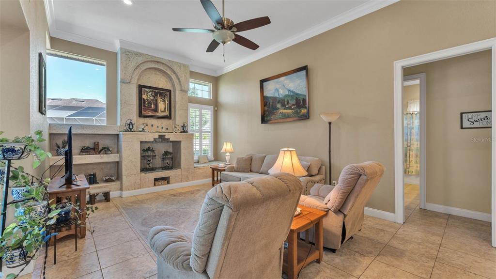 237 McLean Point Winter Haven, FL 33884 - Photo 36 of 85 a living room with furniture a fireplace and a flat screen tv