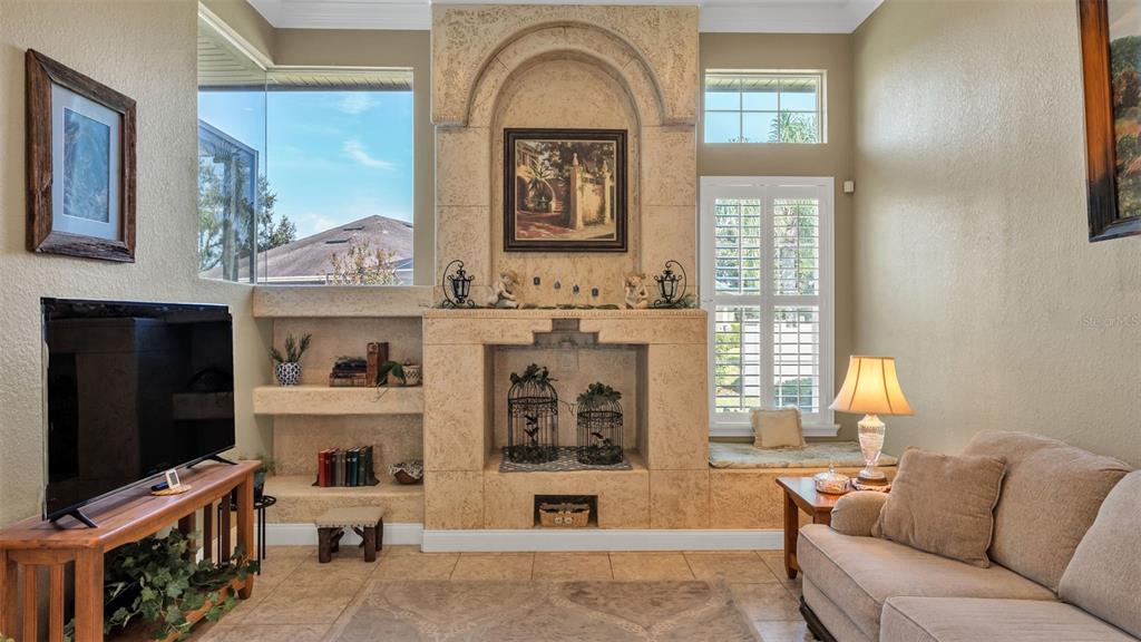 237 McLean Point Winter Haven, FL 33884 - Photo 37 of 85 a living room with furniture a fireplace and a flat screen tv