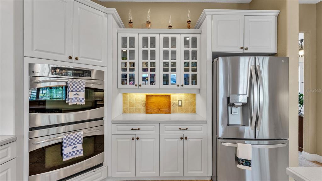 237 McLean Point Winter Haven, FL 33884 - Photo 39 of 85 a kitchen with stainless steel appliances granite countertop a refrigerator and a stove top oven