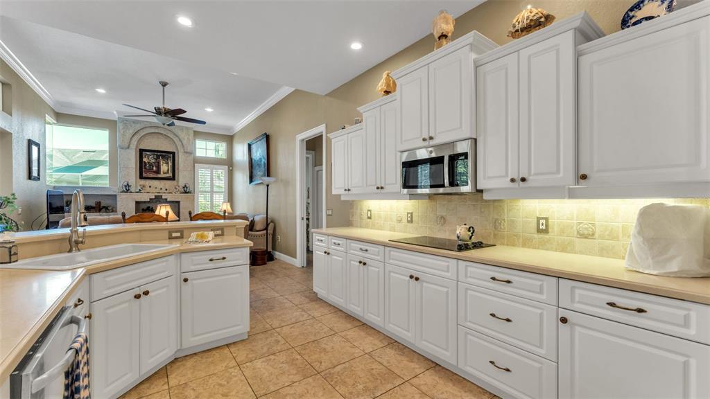 237 McLean Point Winter Haven, FL 33884 - Photo 40 of 85 a large white kitchen with granite countertop white cabinets a sink and dishwasher