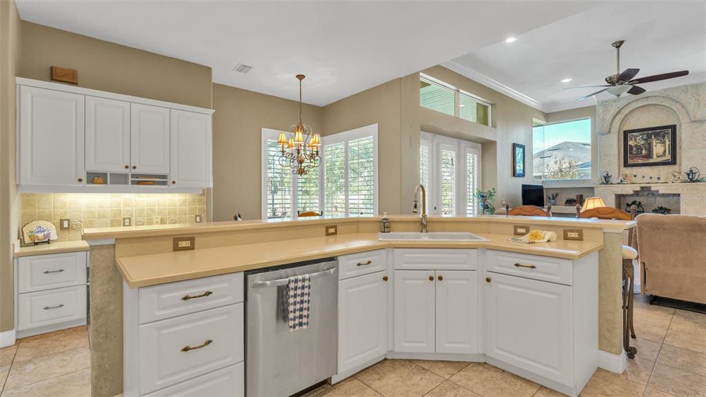 237 McLean Point Winter Haven, FL 33884 - Photo 41 of 85 a kitchen with a sink stove and cabinets