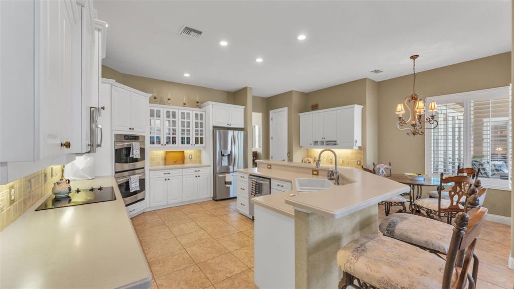 237 McLean Point Winter Haven, FL 33884 - Photo 42 of 85 a large white kitchen with a large window and stainless steel appliances