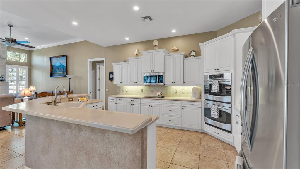 237 McLean Point Winter Haven, FL 33884 - Photo 48 of 85 a kitchen with stainless steel appliances a refrigerator sink and cabinets