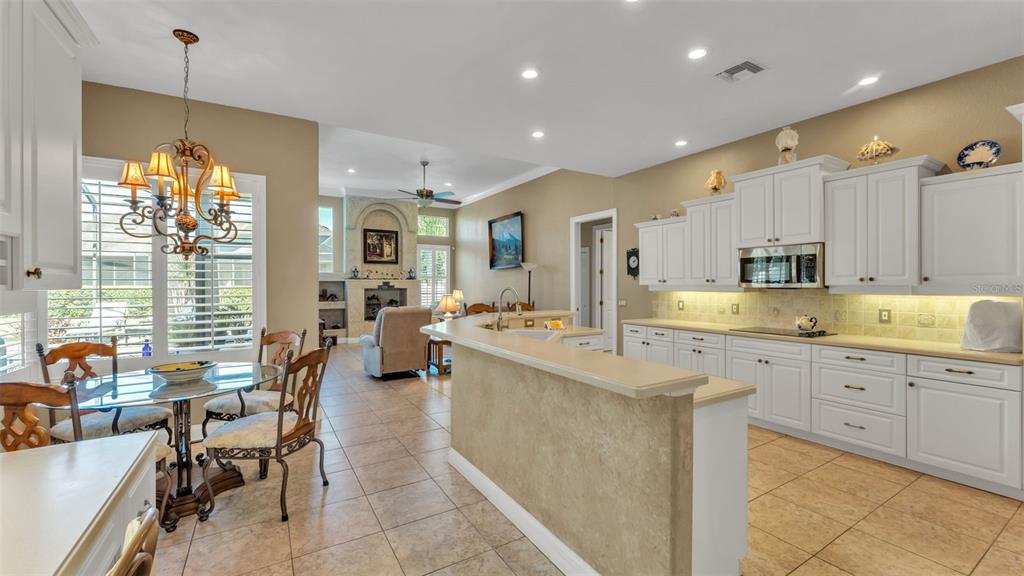 237 McLean Point Winter Haven, FL 33884 - Photo 49 of 85 a large kitchen with cabinets table and chairs