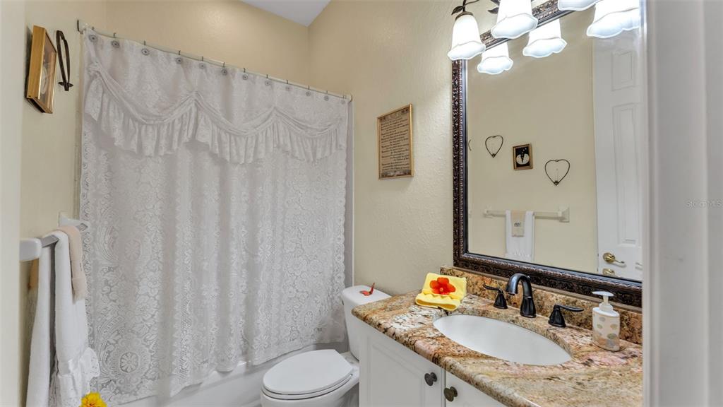 237 McLean Point Winter Haven, FL 33884 - Photo 50 of 85 a bathroom with a granite countertop sink vanity mirror and shower