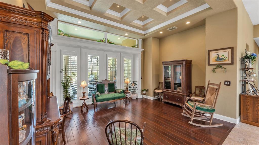 237 McLean Point Winter Haven, FL 33884 - Photo 60 of 85 a living room with furniture floor to ceiling window and wooden floor