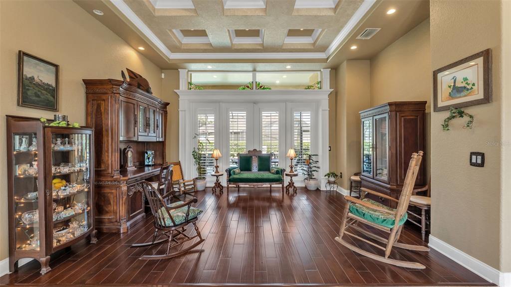 237 McLean Point Winter Haven, FL 33884 - Photo 62 of 85 a living room with furniture a flat screen tv and a floor to ceiling window
