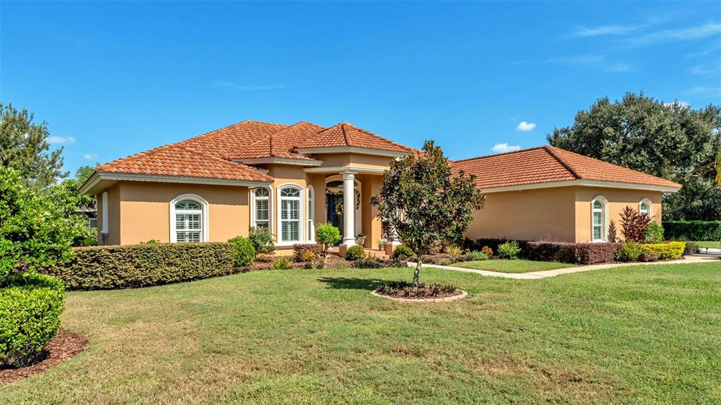 237 McLean Point Winter Haven, FL 33884 - Photo 65 of 85 a front view of a house with a yard