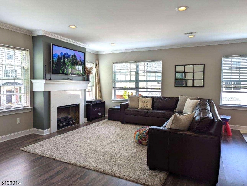 6 Elm Street, Unit 5 Madison, NJ 07940 - Photo 11 of 18 a living room with furniture a flat screen tv and a fireplace