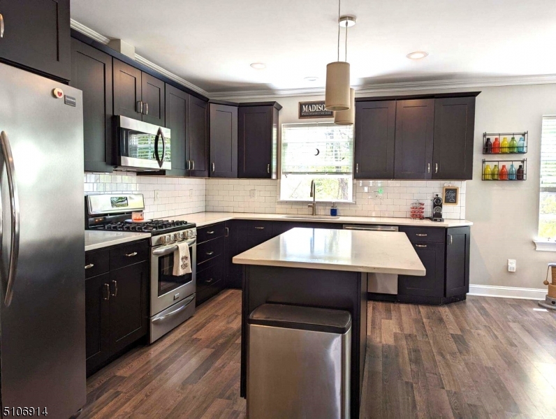 6 Elm Street, Unit 5 Madison, NJ 07940 - Photo 7 of 18 a kitchen with kitchen island granite countertop a sink cabinets and stainless steel appliances