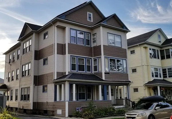 a front view of a residential apartment building with a yard
