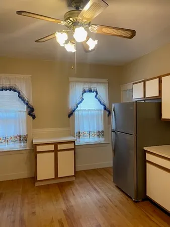 a view of an empty room with wooden floor
