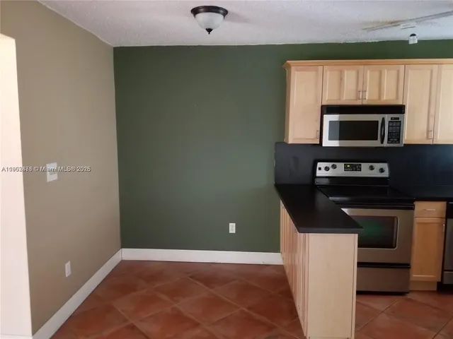 a kitchen with a stove and a microwave