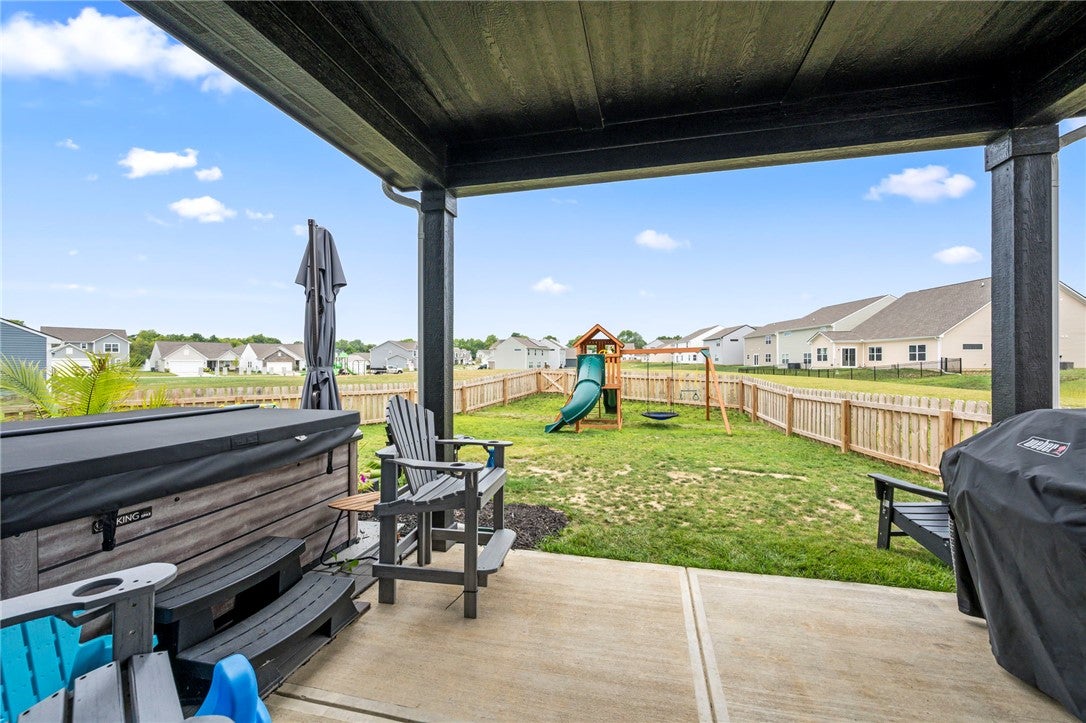 3011 Falls Road Clayton, OH 45315 - Photo 57 of 66 An inviting covered patio offers a private spa and a fenced yard with a playset.