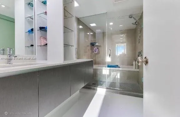 a view of a bathroom with a sink and mirror
