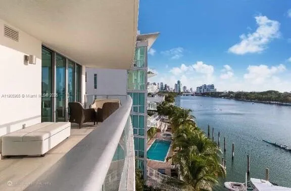 a view of a balcony with lake view and a potted plant