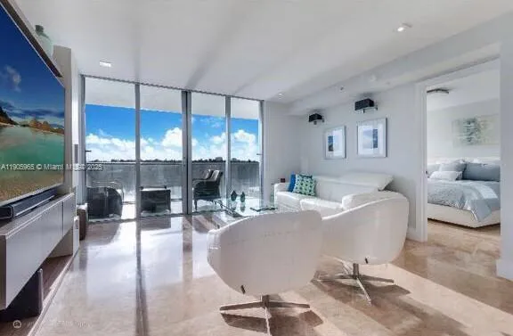 a living room with fireplace furniture and a flat screen tv