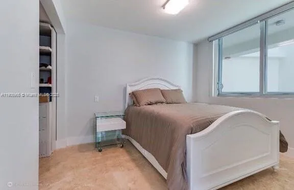 a bedroom with a bed and a cabinets