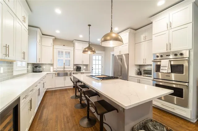 a kitchen with a sink a counter top space and cabinets
