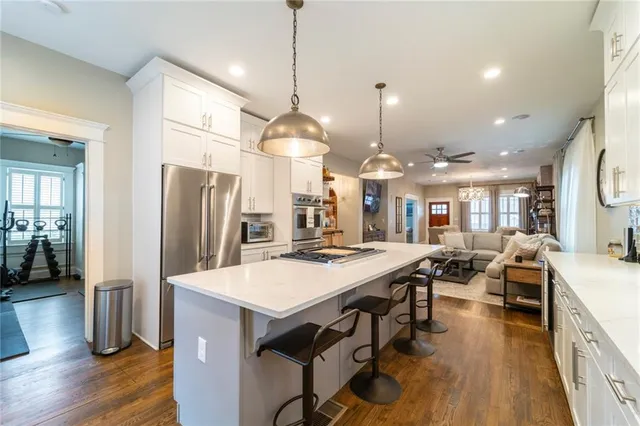 a kitchen with stainless steel appliances granite countertop a stove a sink dishwasher and a refrigerator