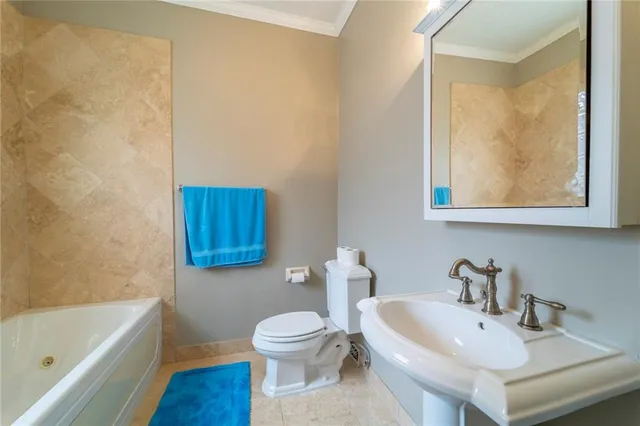 a bedroom with a bed dresser and a large window