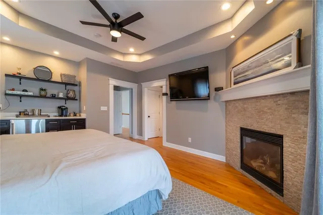 a bathroom with a granite countertop sink a mirror and a shower