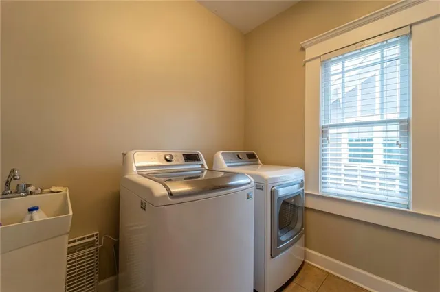 a kitchen with stainless steel appliances kitchen island granite countertop a refrigerator a stove top oven a sink and dishwasher