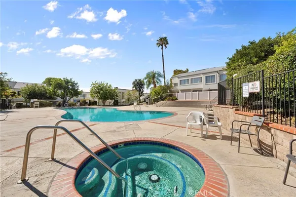 a swimming pool with outdoor seating and yard