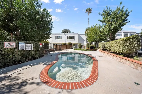 a view of a swimming pool with a house in the background