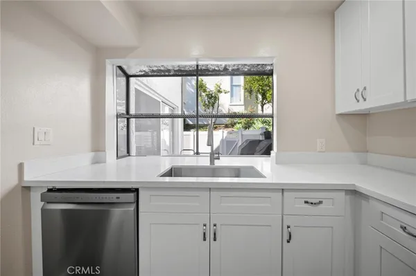 a kitchen with a sink and a window