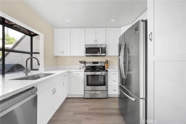 a kitchen with a sink stove and refrigerator