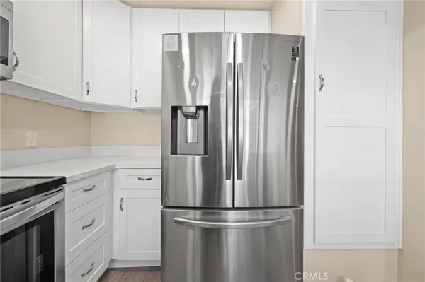 a metallic refrigerator freezer sitting in a kitchen