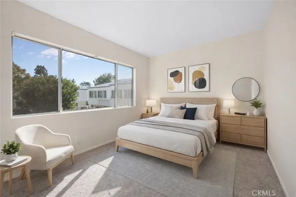 a bedroom with a bed and glass window
