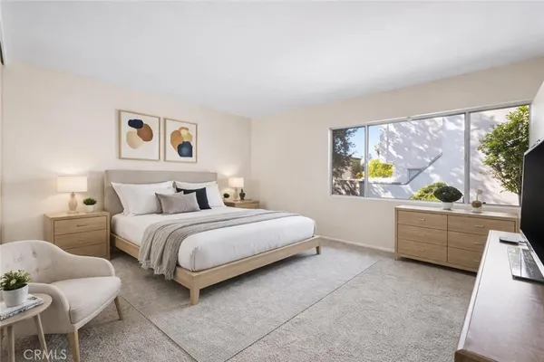 a bedroom with a bed and a couch