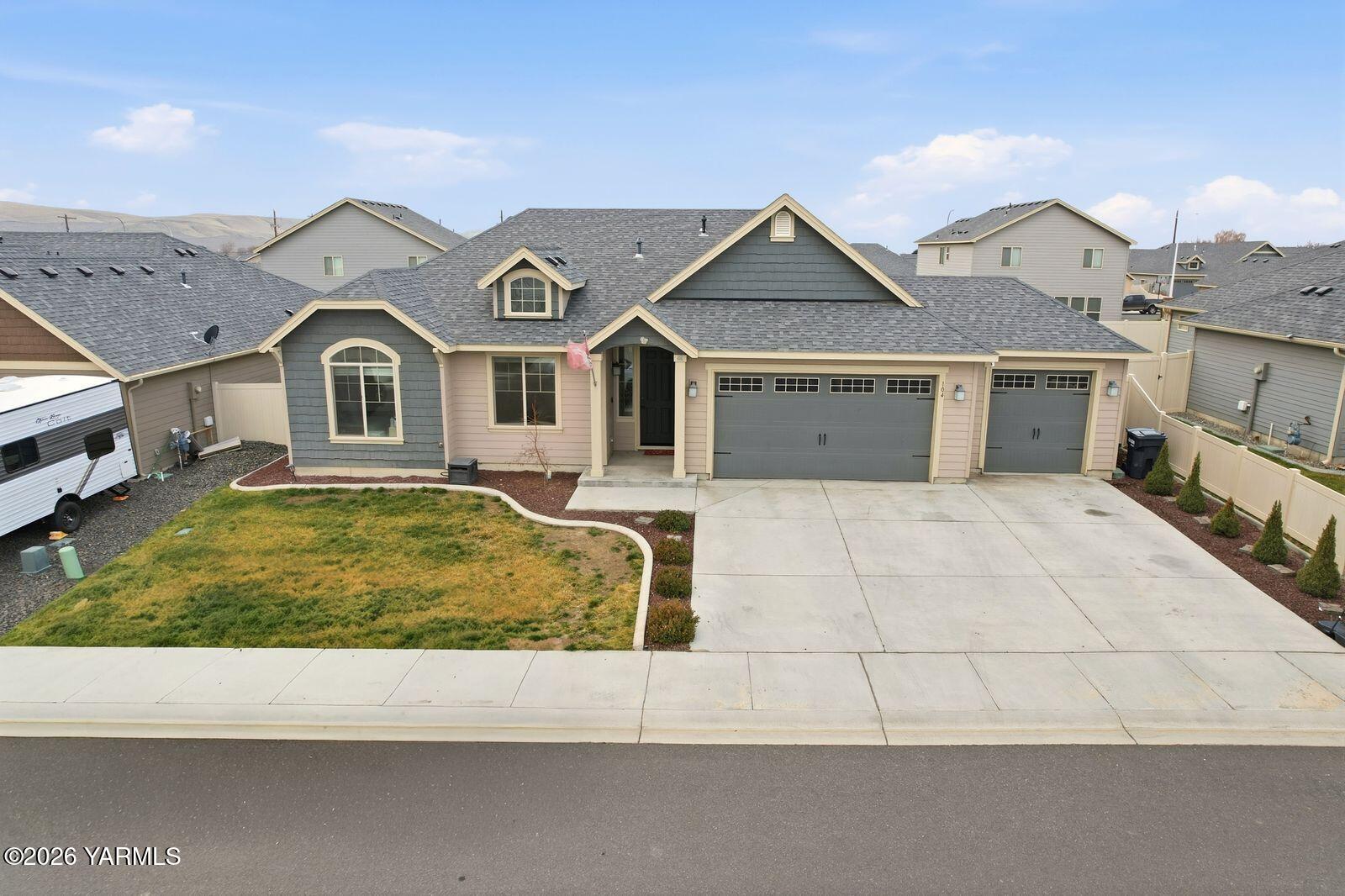a view of a white house with a large tree next to a yard