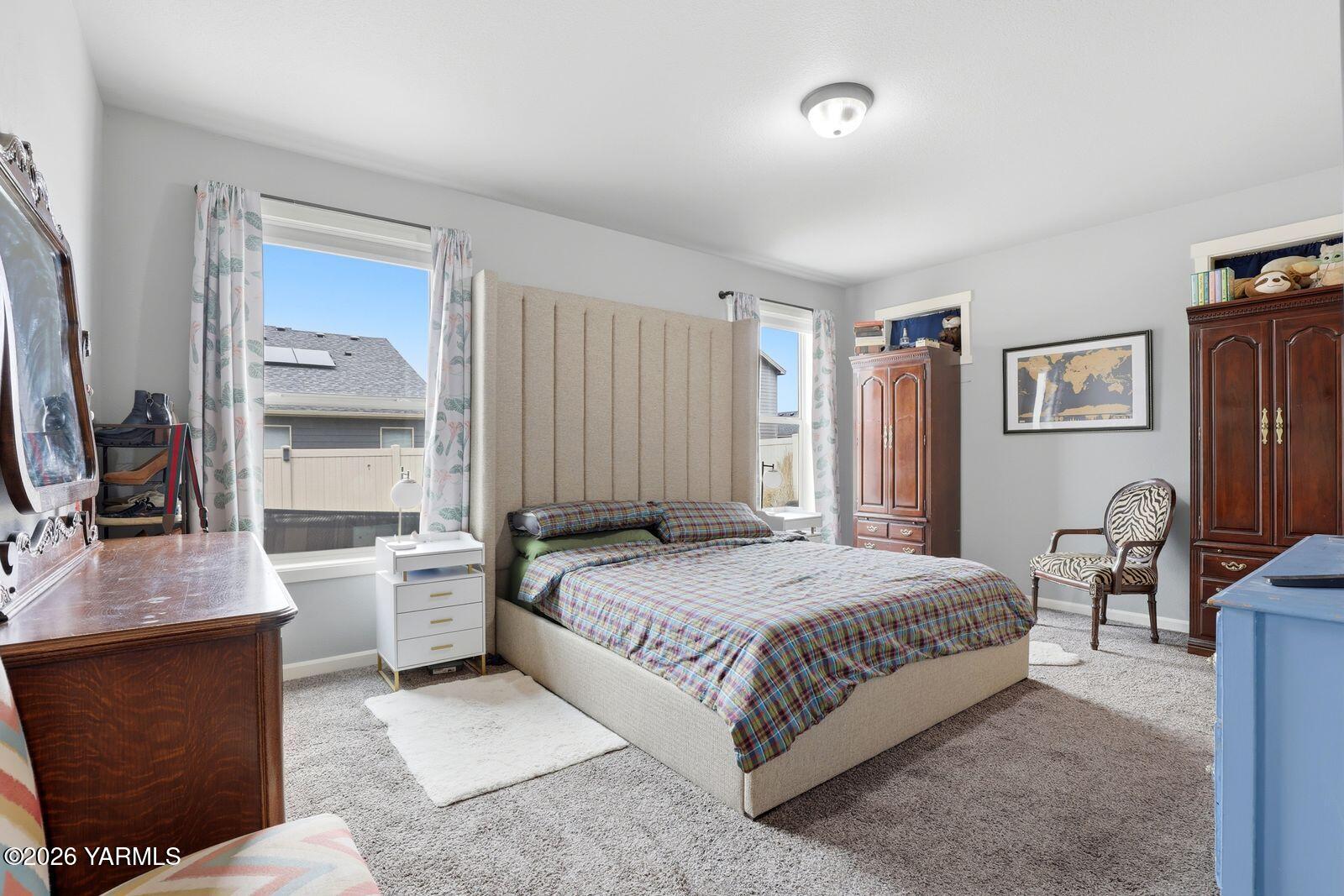 104 Bravo Street Moxee, WA 98936 - Photo 11 of 27 a bedroom with a bed and a flat screen tv