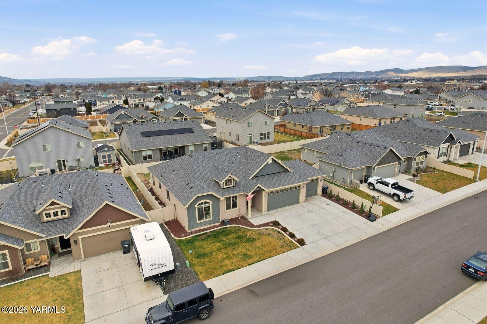 104 Bravo Street Moxee, WA 98936 - Photo 23 of 27 an aerial view of a residential apartment building with a city view