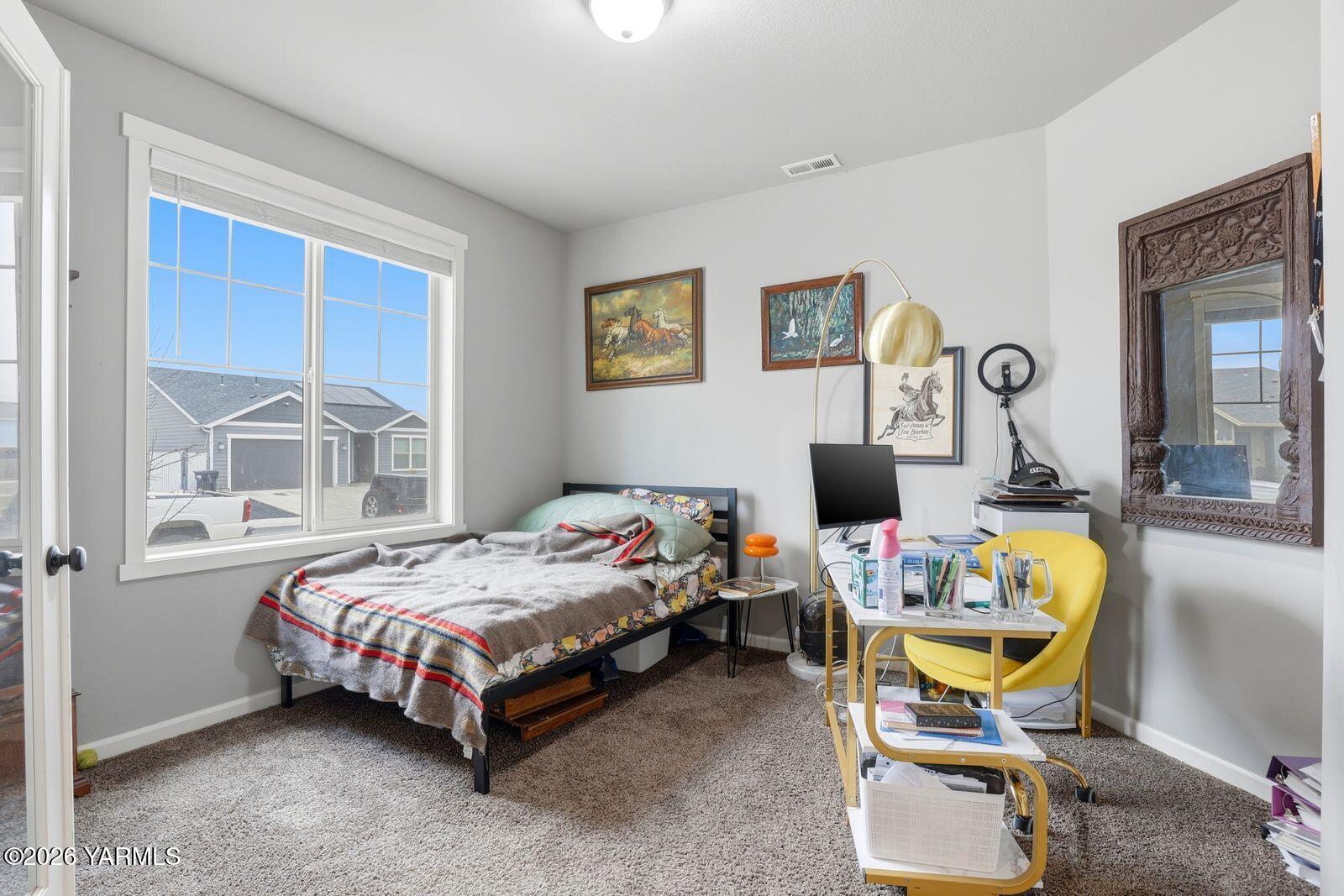 104 Bravo Street Moxee, WA 98936 - Photo 5 of 27 a bedroom that has a bed and a chair in it