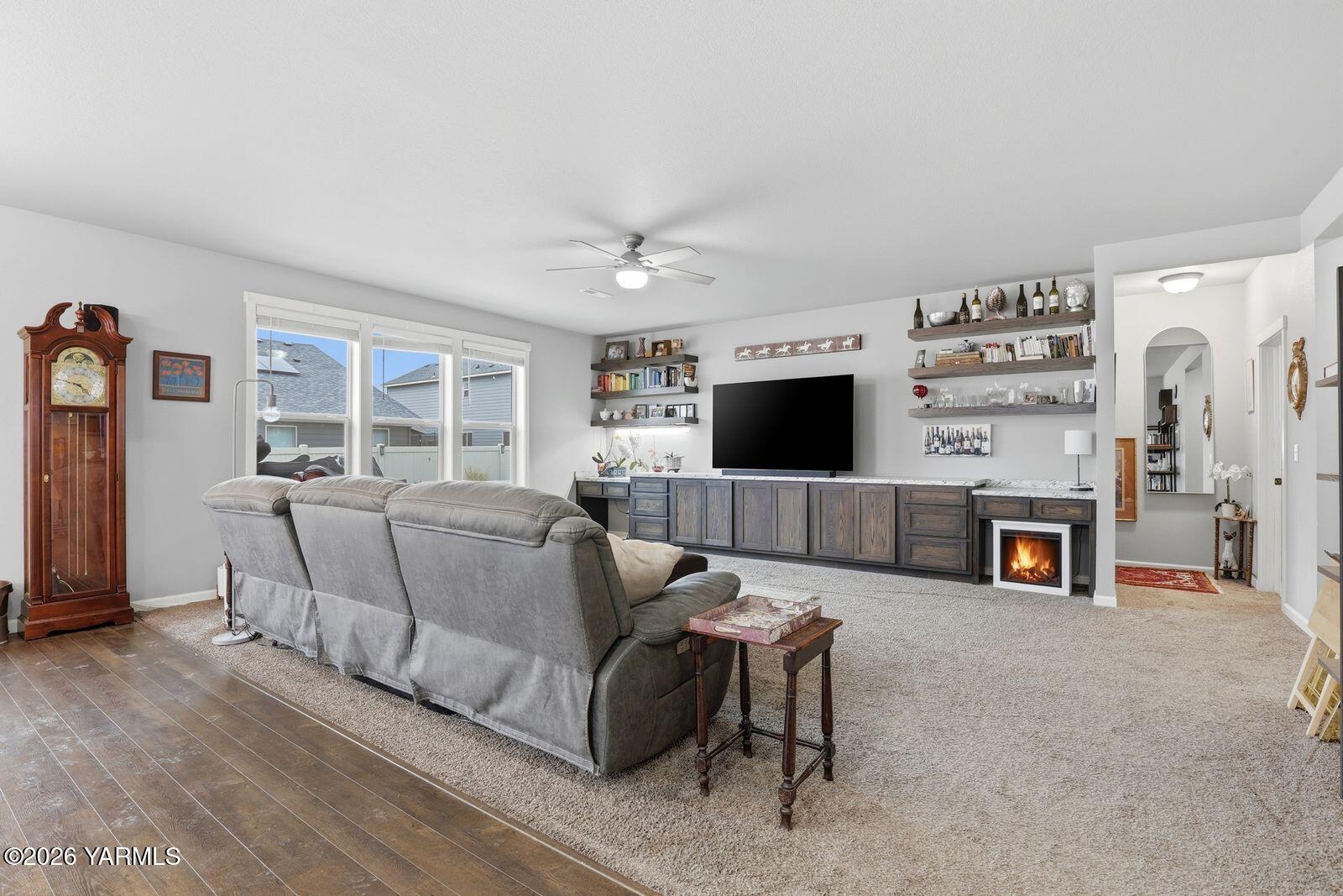 104 Bravo Street Moxee, WA 98936 - Photo 7 of 27 a living room with furniture a flat screen tv and a fireplace