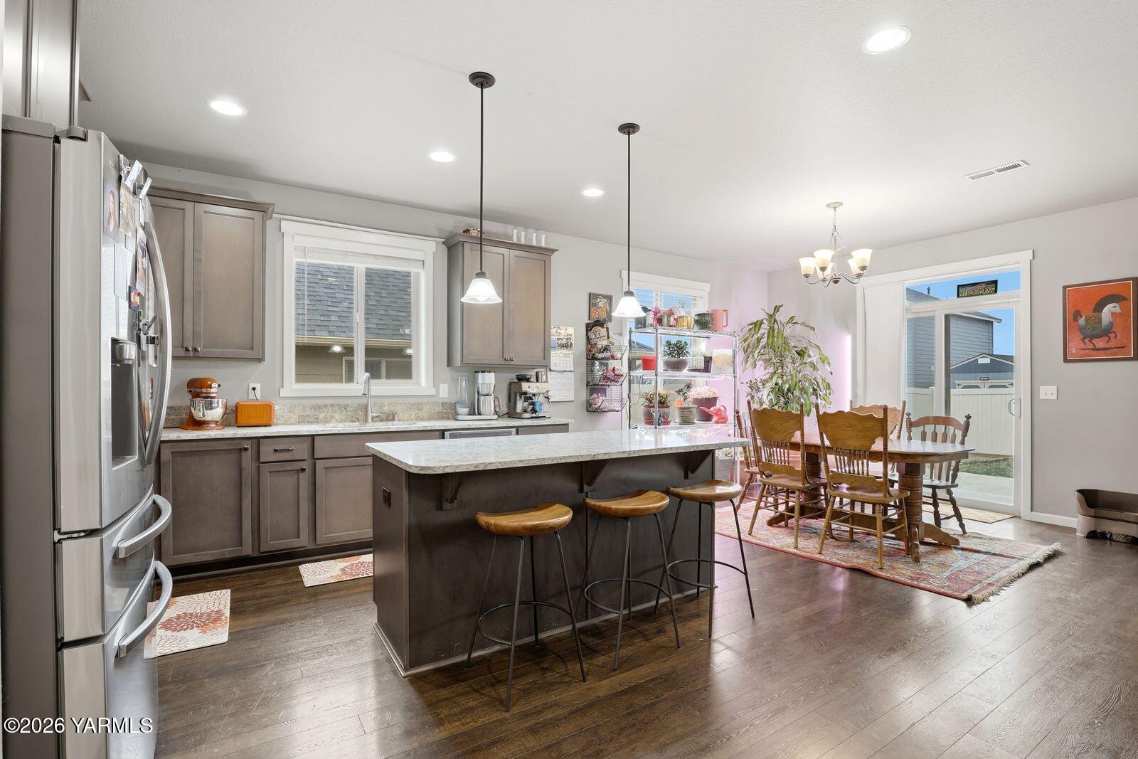 104 Bravo Street Moxee, WA 98936 - Photo 8 of 27 a kitchen with a sink cabinets and wooden floor