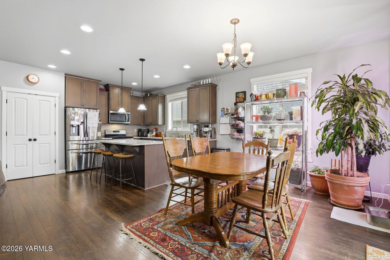 104 Bravo Street Moxee, WA 98936 - Photo 9 of 27 a view of a dining room with furniture and a chandelier