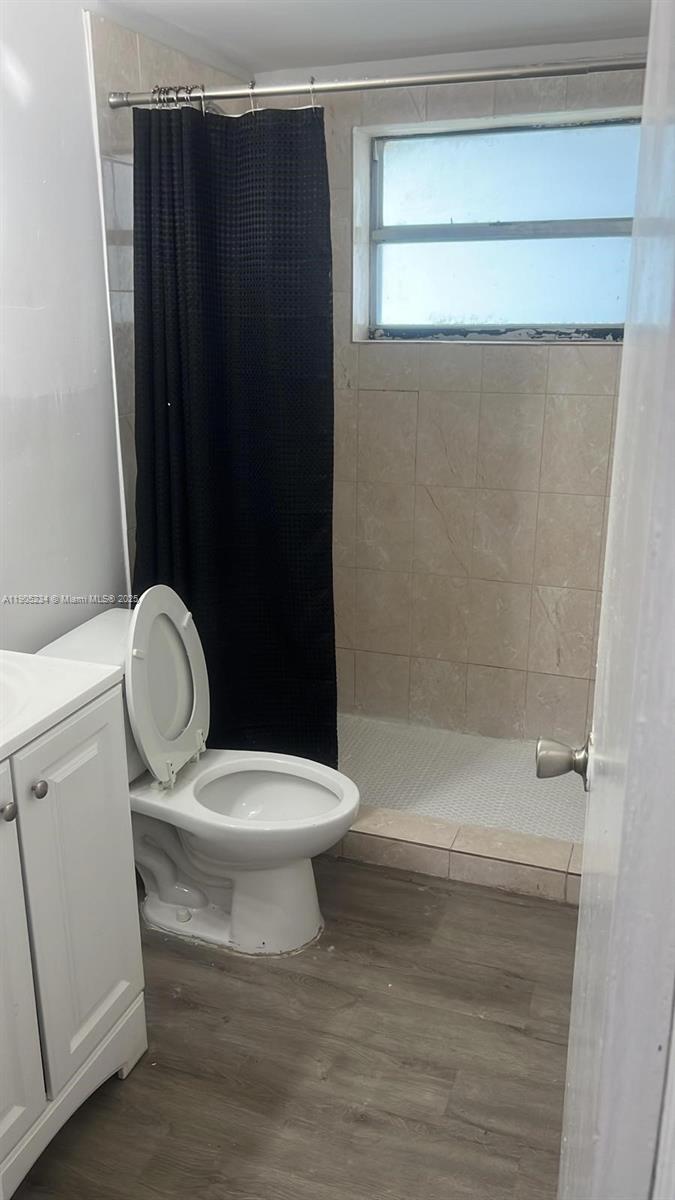 7230 Northwest 3rd Street, Unit 4 Miami, FL 33126 - Photo 12 of 13 a bathroom with a toilet and a shower