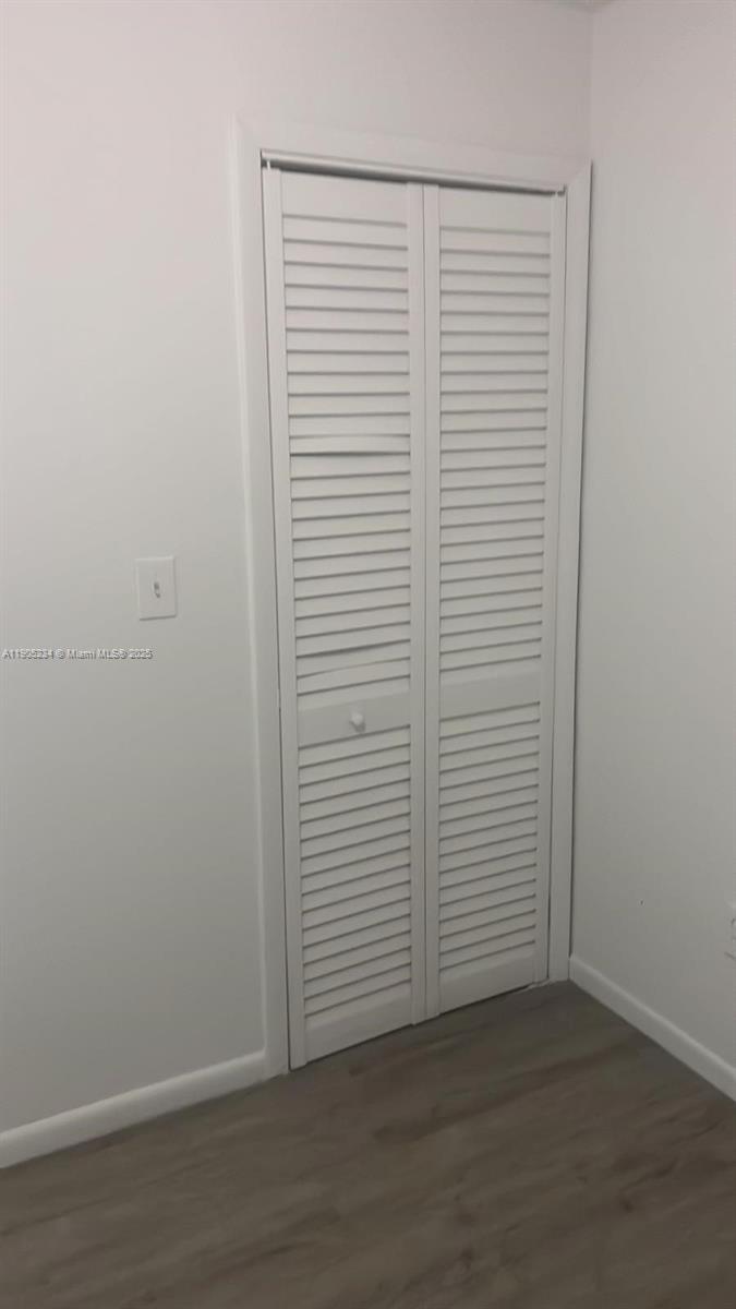 7230 Northwest 3rd Street, Unit 4 Miami, FL 33126 - Photo 10 of 13 an empty room with wooden floor